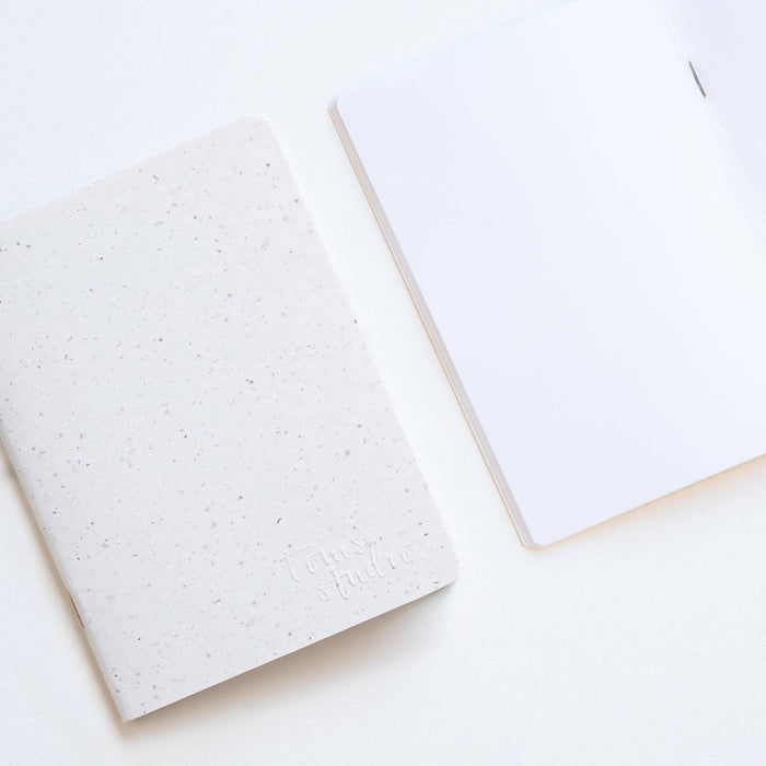 Tom's Studio x Coffeenotes A6 Notebook in 'Grounds' white, with plain pages, made from recycled coffee cups and eco-friendly materials.