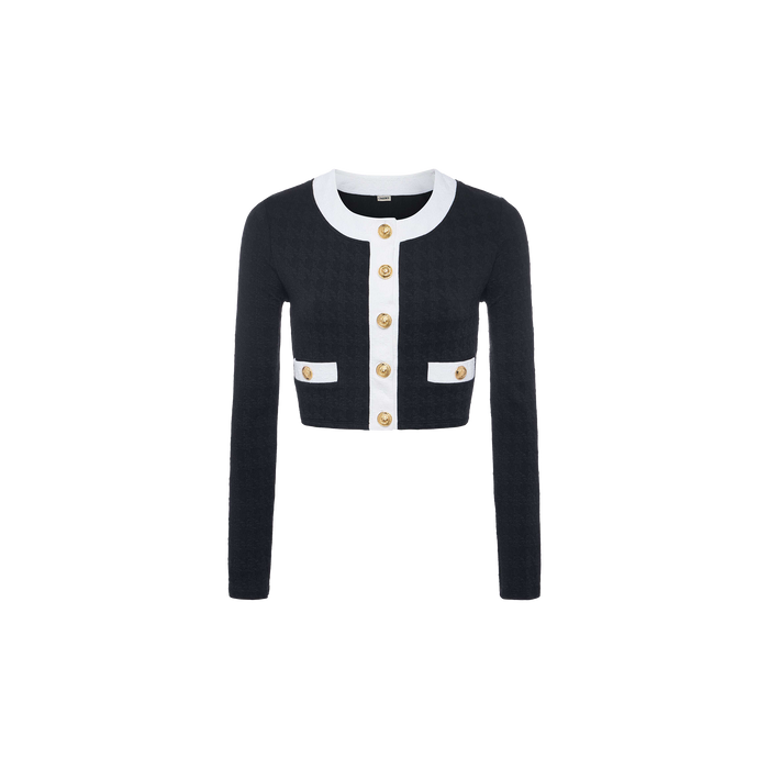 The Adaline Cardigan Cover-Up is a cropped, long-sleeve black cardigan featuring white trim, gold buttons down the front, and two front pockets. Designed as a stylish swimsuit cover-up or versatile beach-to-boat layer, it is displayed on a plain white background.