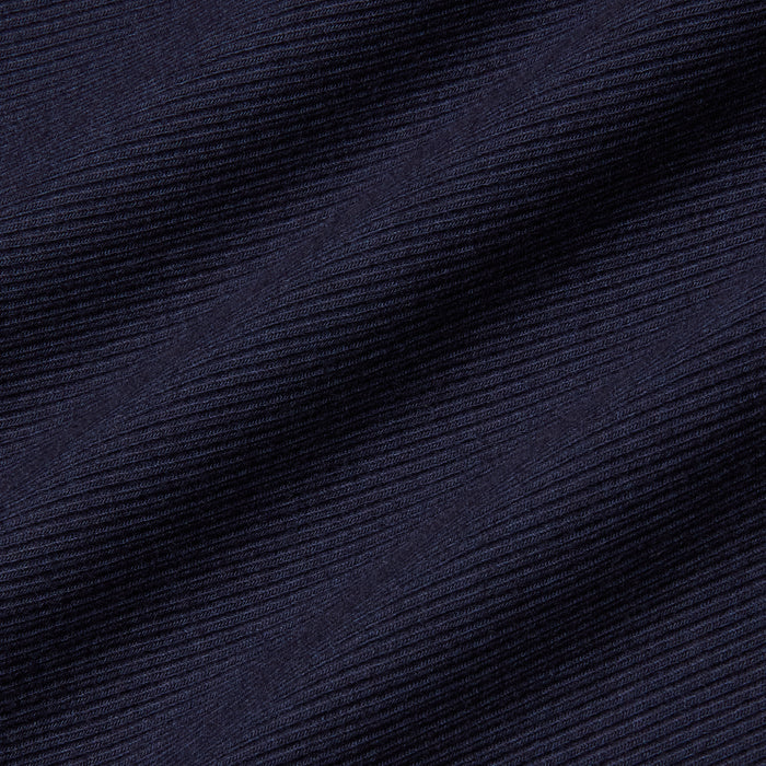 Close-up of the Adira Scoopneck Tank in dark navy blue stretch rib fabric, featuring diagonal textured lines with fine horizontal ridges and subtle light reflections.