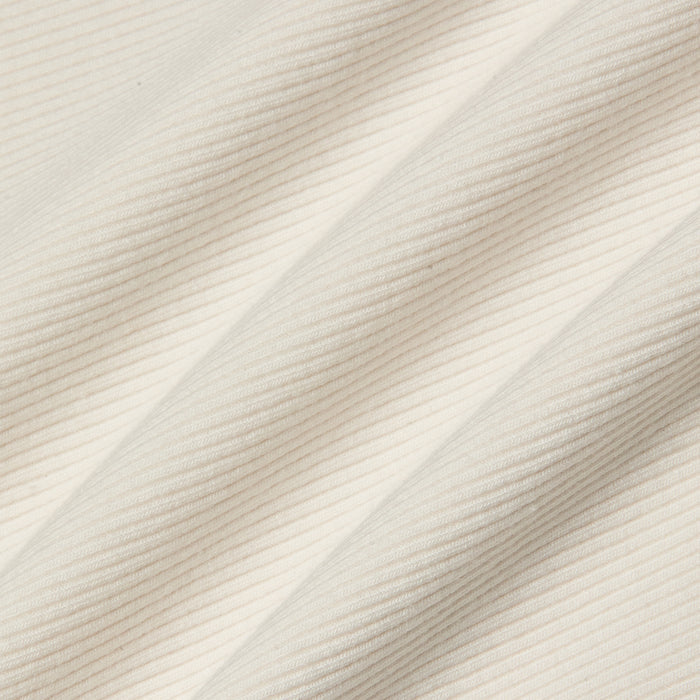 Close-up of the Adira Scoopneck Tank in cream-colored fitted stretch rib fabric, featuring diagonal ridges that form a textured pattern of fine, parallel lines.