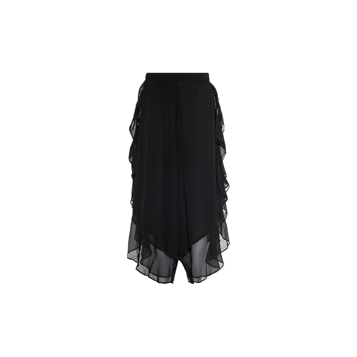 The Adonis Cover-Up Pant features black sheer chiffon fabric with an elastic waistband and layered, asymmetrical ruffle detailing along the sides and hem, making it a stylish choice for effortless poolside style, shown here against a plain white background.