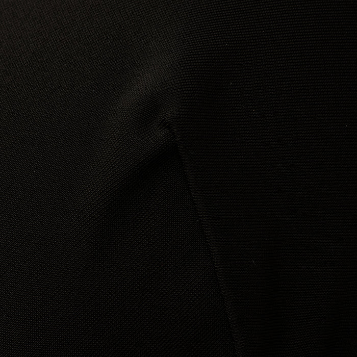 Close-up of the Adrienne Bikini Top in black, showcasing visible fabric texture and seams, with subtle folds and shadows reminiscent of Trapunto stitching.