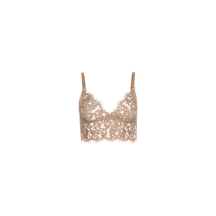 The Aislin Lace Bralette is showcased against a plain white background, featuring thin adjustable straps, a beige floral sheer stretch lace design, and delicate scalloped edges.