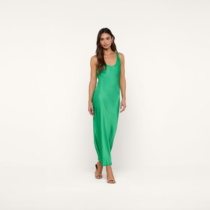 A woman wearing the Akiya Satin Maxi Dress in island green and tan heels stands against a plain white background, looking forward with a neutral expression.