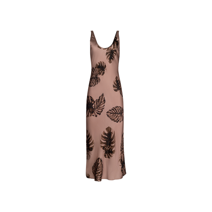 Sleeveless, light brown Akiya Satin Maxi Dress featuring a scoop neckline and black palm leaf print, cut on the bias from luxurious satin fabric, displayed on a plain white background.