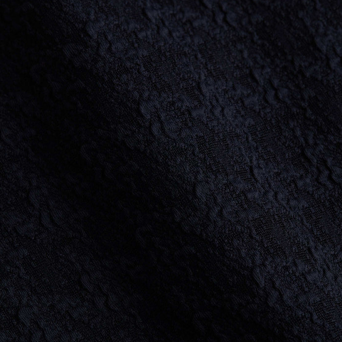 Close-up of the Alexandria Bikini Top in black, featuring textured bouclé fabric with subtle wavy patterns and a slightly raised, tactile surface.
