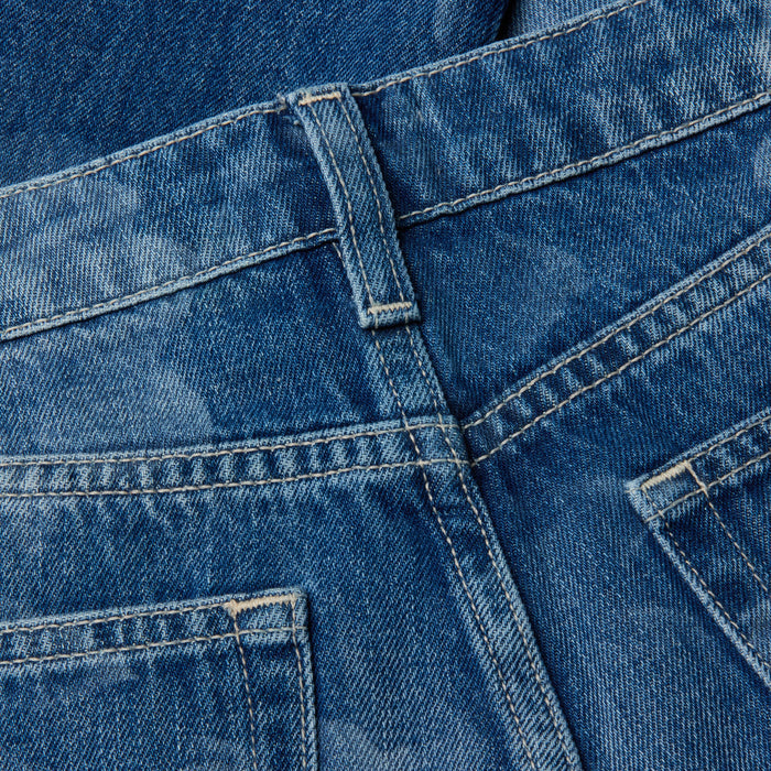Close-up of the Alicent Wide-Leg Jean in blue all-cotton denim, featuring back pockets, belt loops, sturdy seams, and softly faded areas that highlight the fabric’s texture and detailed stitching.