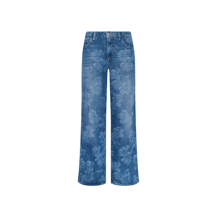 The Alicent Wide-Leg Jean features a sneaker-length, wide-leg blue denim design with a subtle floral print, complete with button and zipper closure and front and back pockets, displayed against a plain white background.