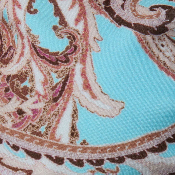 Close-up of the Alisha Bikini Top fabric, featuring an ornate paisley pattern in brown, beige, and pink set against a vibrant turquoise background. This intricately designed textile is ideal for swim separates, offering both standout style and UPF 50 sun protection.