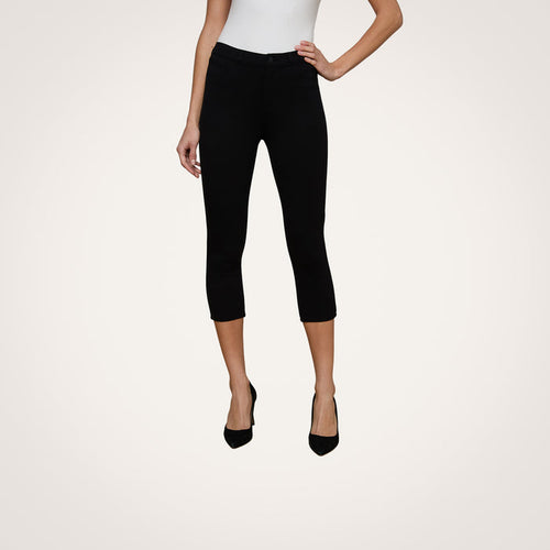 Wearing the Amaris Pedal Pusher in black, this woman pairs the body-hugging pants with a white sleeveless top and black heels. Only her body from shoulders down is shown against a plain light background.
