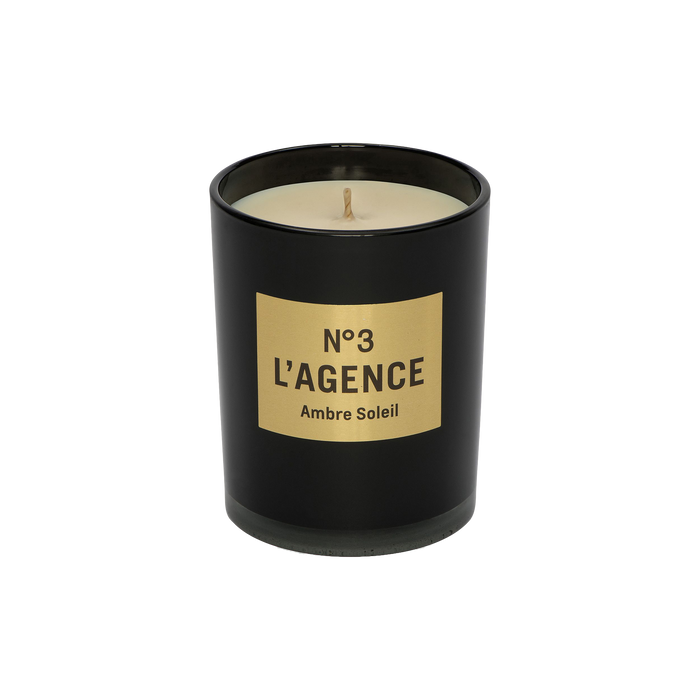 The Ambre Soleil black candle jar, labeled No. 3, showcases beige soy-blend wax with a centered wick, all set against a plain white background.