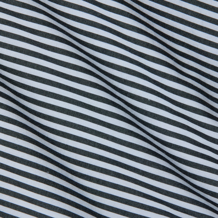 Close-up of fabric with diagonal black and white stripes, featuring a smooth texture and gentle folds—an ideal match for the Amiya Cover-Up Short, perfect for resort dressing.