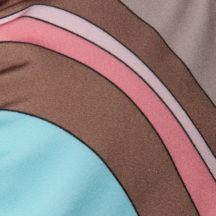Close-up of the Annabelle Bikini Top fabric, showcasing an abstract swirl print with curved stripes in brown, pink, lilac, and light blue. The material exhibits a slight sheen and visible texture, highlighted by smooth, overlapping lines and subtle shadows.