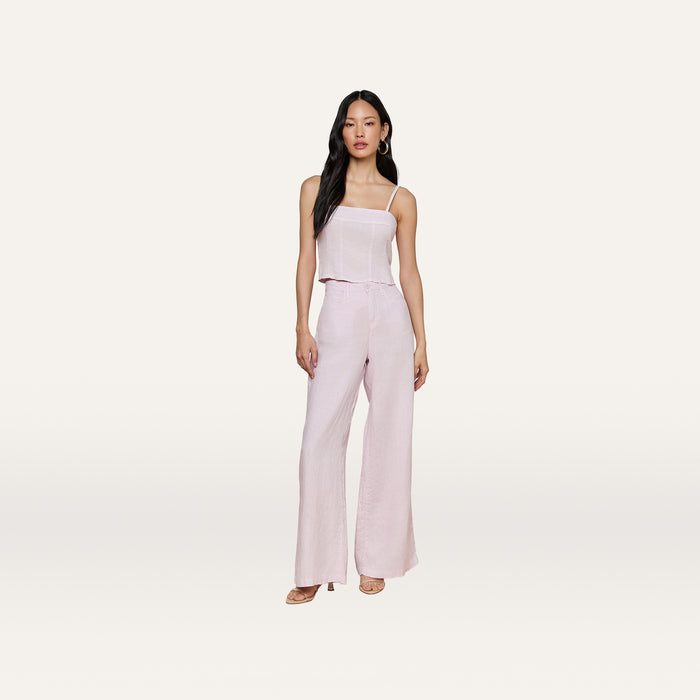 A woman wearing the Arlin Linen Tank in light pink paired with matching wide-leg pants, standing against a plain, light background and facing forward with a neutral expression.