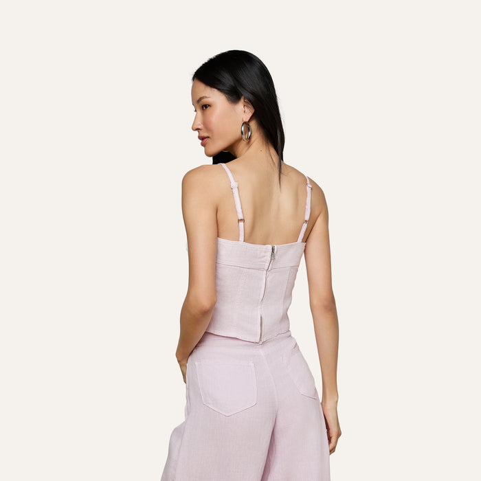 Woman with long black hair wearing the Arlin Linen Tank in light pink, paired with matching wide-leg pants, shown from the back against a plain light background.
