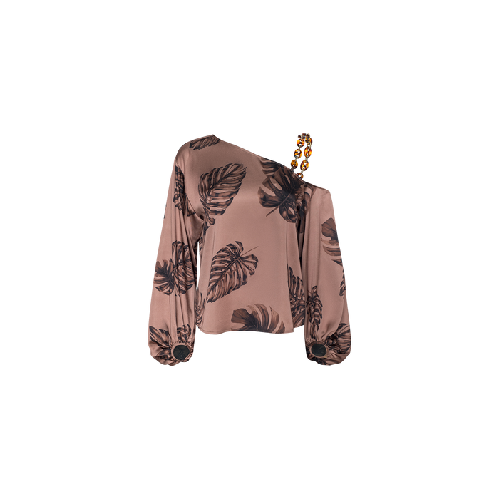 The Asami Chain One-Shoulder Blouse features a pinkish-brown base with a black leaf print and is accented by a beaded strap on one shoulder. The satin sleeves are finished with matching round black details at the cuffs, adding a stylish touch to this unique blouse.