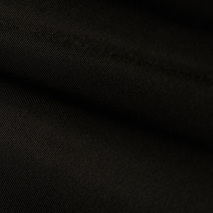 Close-up of black fabric with diagonal weave pattern and soft folds, highlighting the fine texture and subtle highlights on the surface, reminiscent of the refined Ashleigh Bikini Bottom.