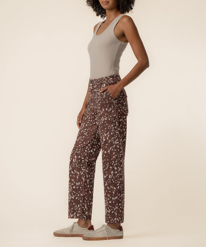 Cocoa high-rise relaxed leg jeans with white speckle print, worn with beige tank top and white sneakers.