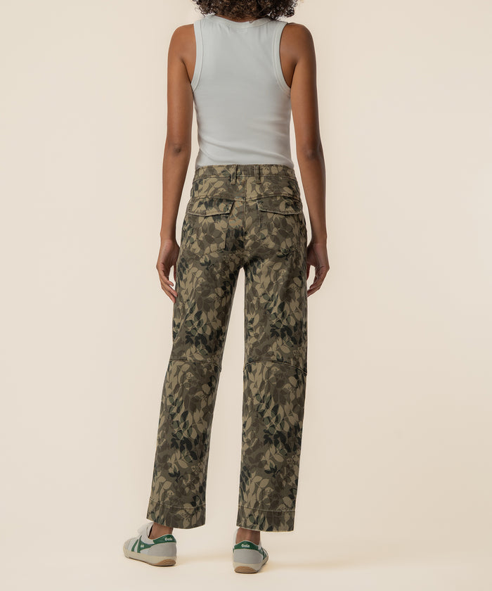 Olive camouflage relaxed-leg pants with back pockets, shown from behind on a model wearing a white tank top.
