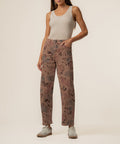 Mauve twill pants with floral print, high-rise waistband, and relaxed straight leg fit.