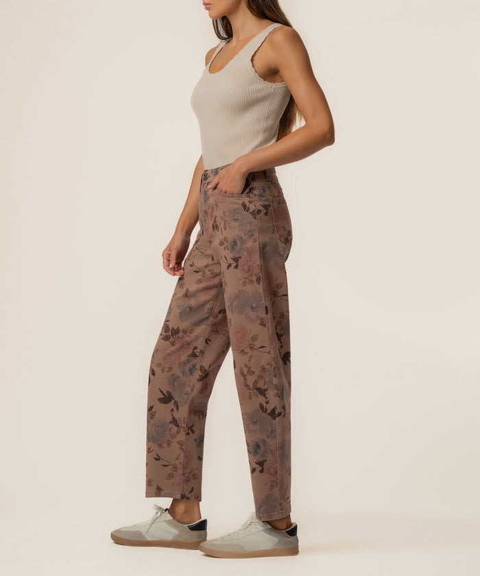 Mauve twill pants with floral print, high rise and relaxed leg fit, worn with cream ribbed tank top.