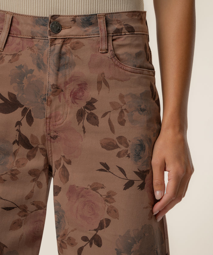 Mauve twill pants with floral print featuring high rise waistband and relaxed leg fit.