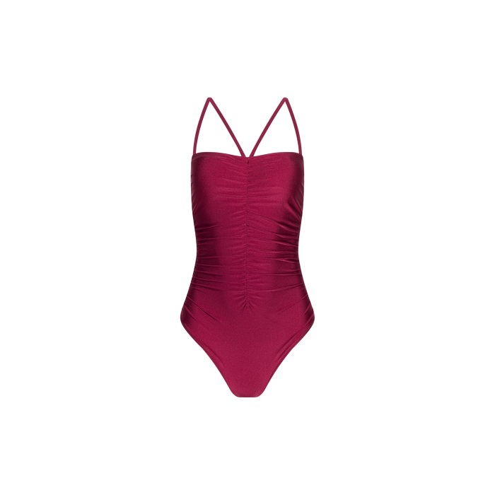 The Aubrey Ruched One-Piece Swimsuit in dark pink features thin shoulder straps and textured shirring down the center front, displayed on a plain white background.