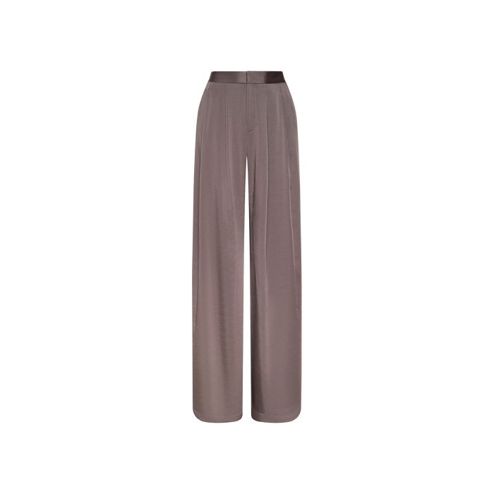 The Aubrie Satin Pant features a wide-leg, high-waisted silhouette in a cardamon brown shade, crafted from smooth, shiny satin with a tailored waistband and subtle front pleats, shown against a plain white background.