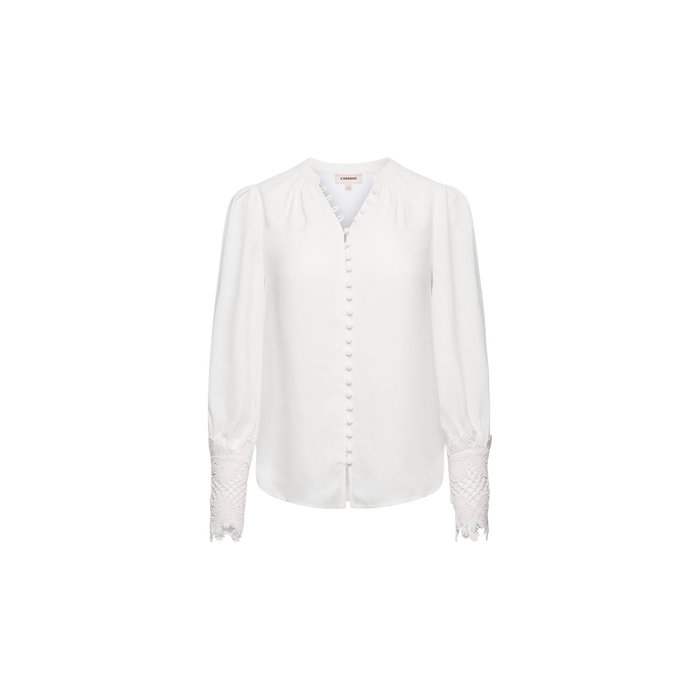 Ava Blouse in ivory, featuring fabric-covered buttons down the front and vintage-inspired scalloped guipure lace detailing on the cuffs, displayed on a plain white background.