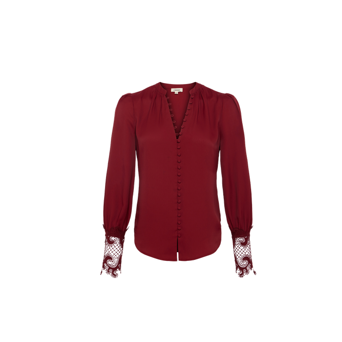 The Ava Blouse is a long-sleeve, deep red, vintage-inspired top featuring fabric-covered buttons down the front and guipure lace detailing at the cuffs, shown against a plain white background.