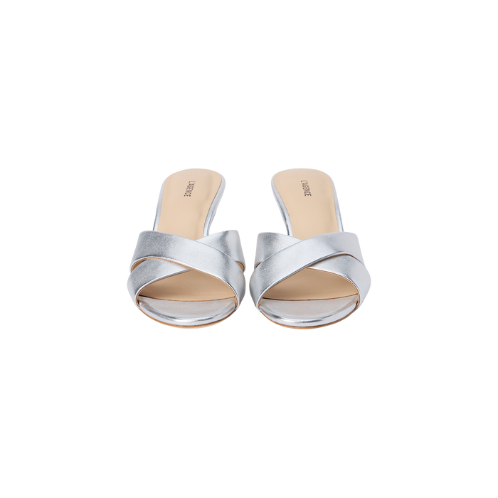 A pair of Aveline Kitten-Heel Sandals in silver metallic leather, featuring an open toe, strappy vamp, and beige insoles, displayed against a white background.