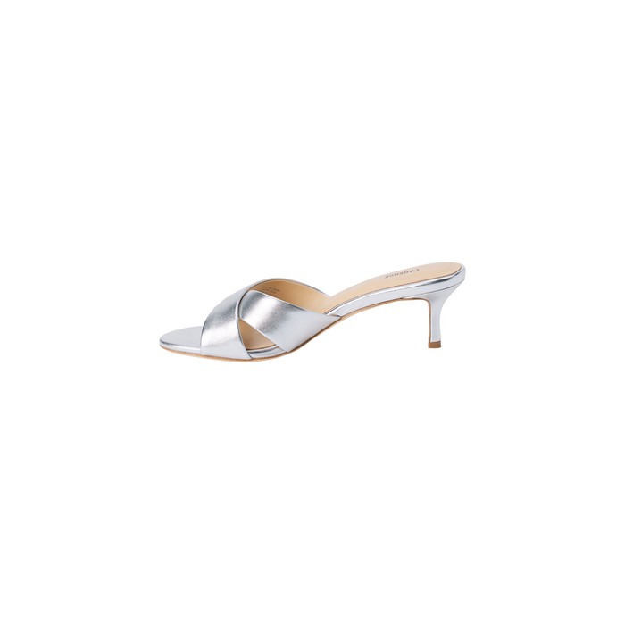 Aveline Kitten-Heel Sandal in silver metallic leather showcases a low kitten heel, open toe, and wide crisscross straps, displayed on a white background.