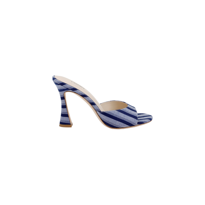The Avery Open-Toe Mule showcases a flared heel with a blue denim upper adorned with white diagonal stripes, featuring an open-toe and open-back design, all displayed against a plain white background.