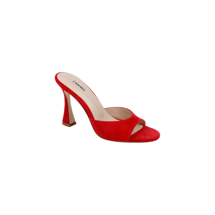 The Avery Suede Open-Toe Mule, featuring a striking red suede finish, an open toe, and a sculpted stiletto heel, is showcased against a plain white background.