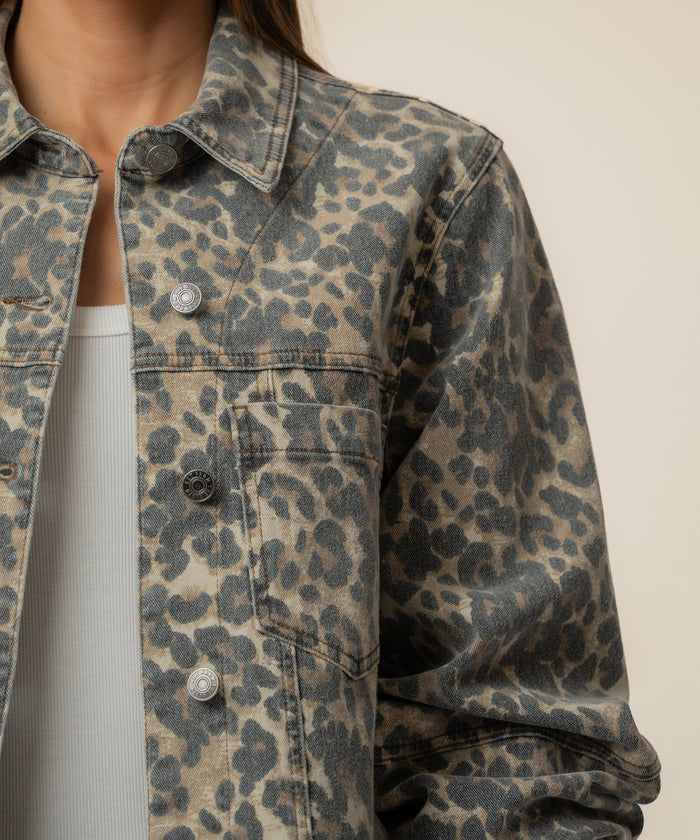 Tan and brown leopard print denim jacket with button front and collar.