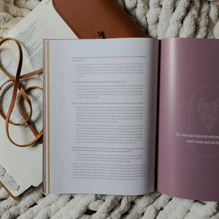 Be Still Issue 36 Magazine opened to the Questions and Answers page laying on an open bible on a white knitted blanket