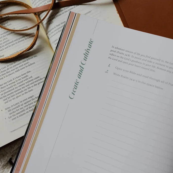 Be Still Issue 36 Magazine opened to the Create and Cultivate page laying on an open bible on a white knitted blanket