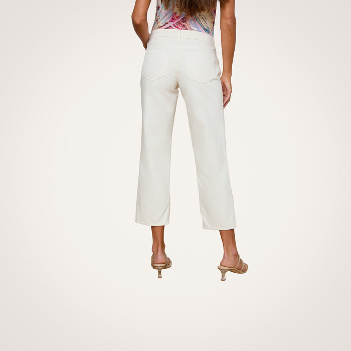 A woman is shown from the back against a plain white background, wearing the Blaine Cropped Stovepipe Jean in off-white all-cotton denim with a slouchy straight-leg fit, paired with heeled sandals.
