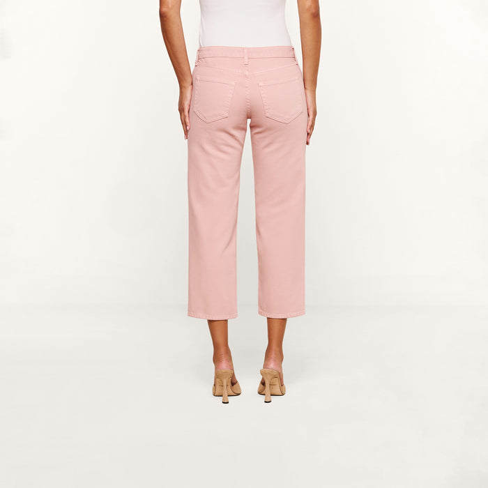A person is shown from the back against a plain white background wearing the Blaine Cropped Stovepipe Jean in light pink, paired with a white sleeveless top and beige heeled sandals.
