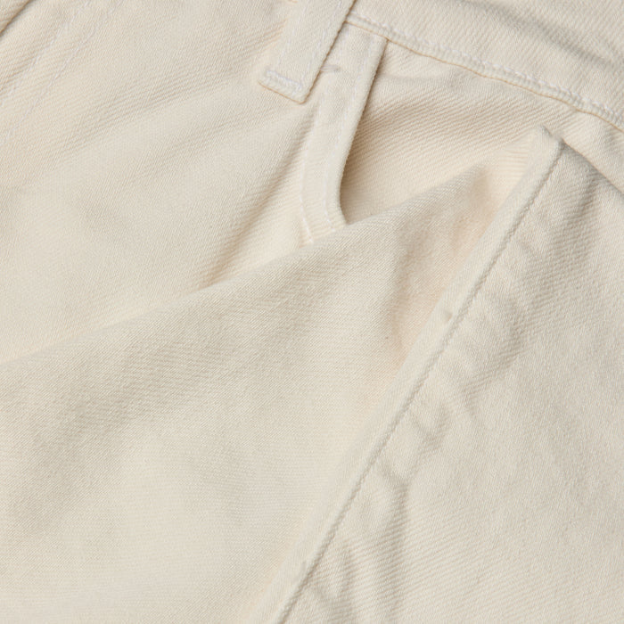 Close-up of the front pocket and waistband of the Blaine Cropped Stovepipe Jean in cream-colored all-cotton denim, highlighting the fabric’s texture, precise stitching, and part of a belt loop.