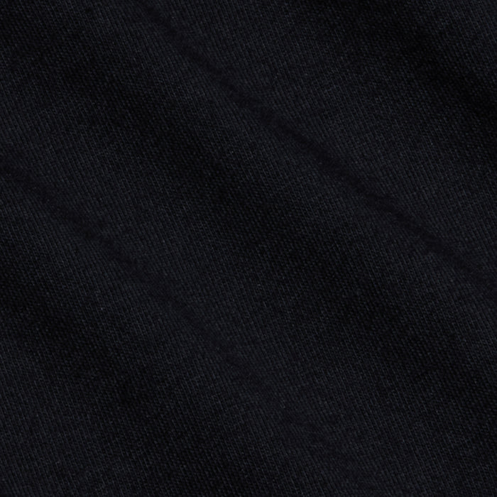 Close-up of black fabric with a subtle diagonal weave pattern and faint texture lines, highlighting the sturdy quality of Supima cotton featured in the Brianna Cotton V-Neck Tee.