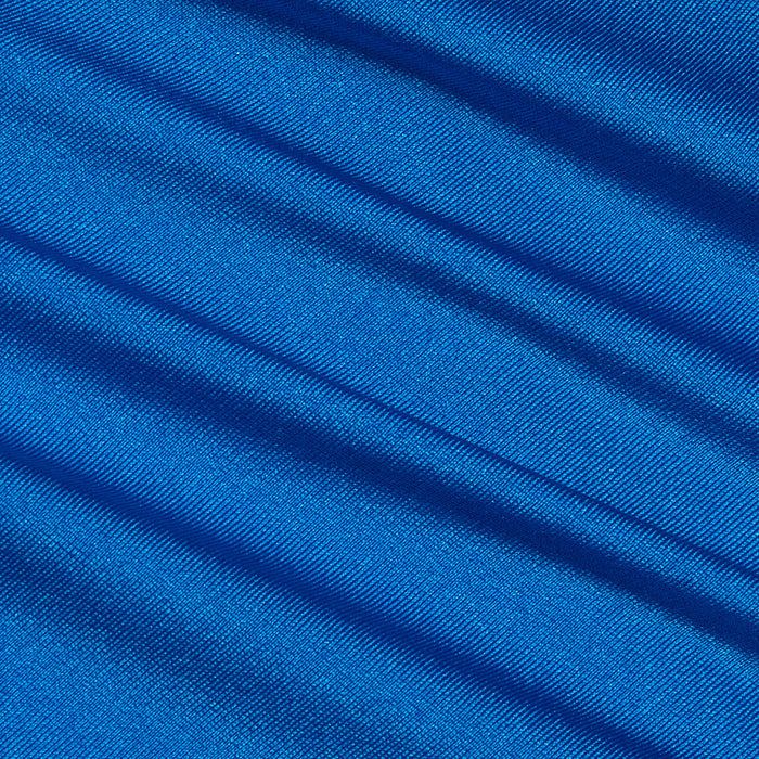 Close-up of the Britt Tie-Side Bikini Bottom in capri blue, showcasing its smooth, shiny fabric with diagonal soft folds. The light catches the ridges, creating a shimmering effect across the material.