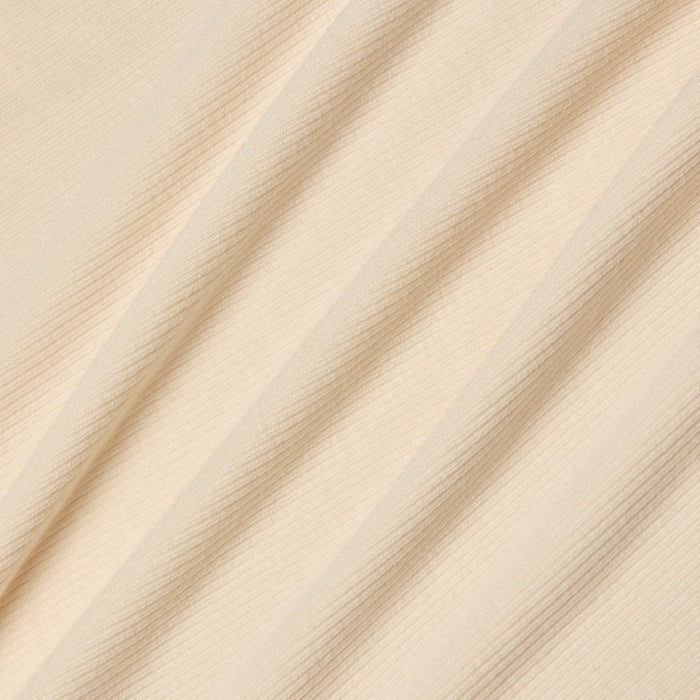 Beige ribbed fabric with diagonal folds, showcasing a subtle striped texture under soft, even lighting. Perfect for the Cael Tank Top, the material appears smooth, lightweight, and ultra soft—ideal for layering or wearing on its own.