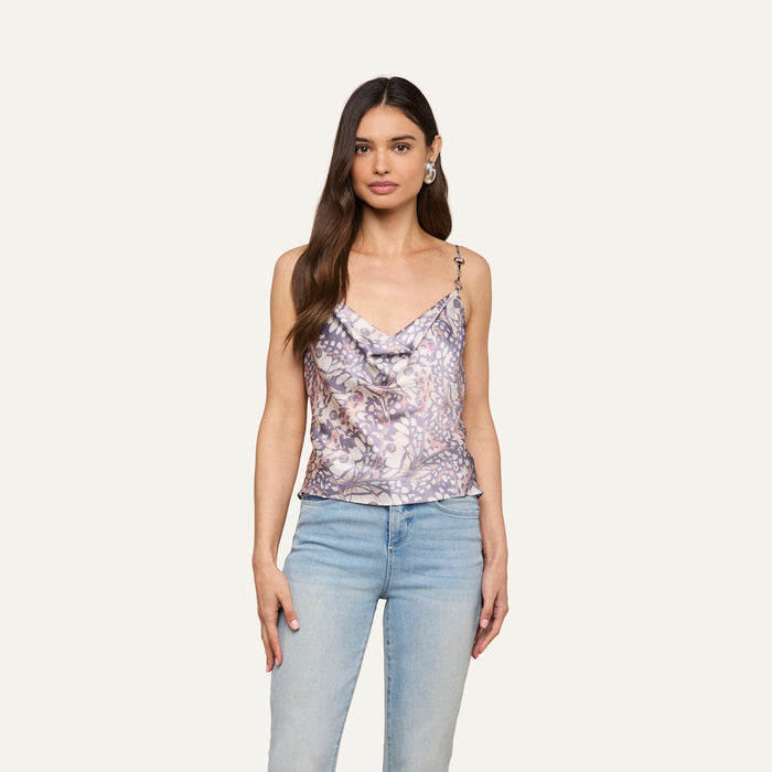 A woman with long brown hair is wearing the Calista Satin Camisole and light blue jeans, standing against a plain light background.