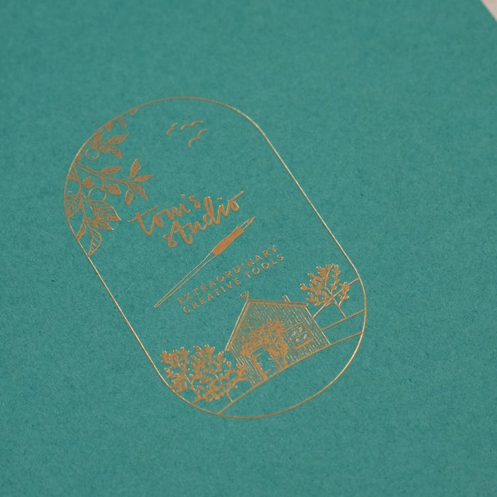 Detail shot of the gold foil on the cover of Tom's Studio A5 calligraphy practice pad