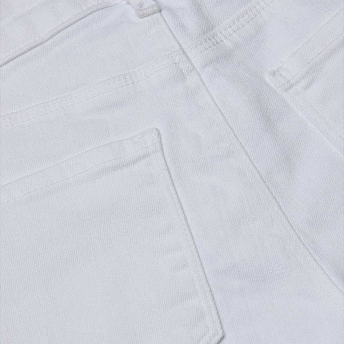 Close-up of the back pocket and seam details on the Cara Low-Rise Bootcut Jean in white, highlighting the texture and stitching of its denim fabric.