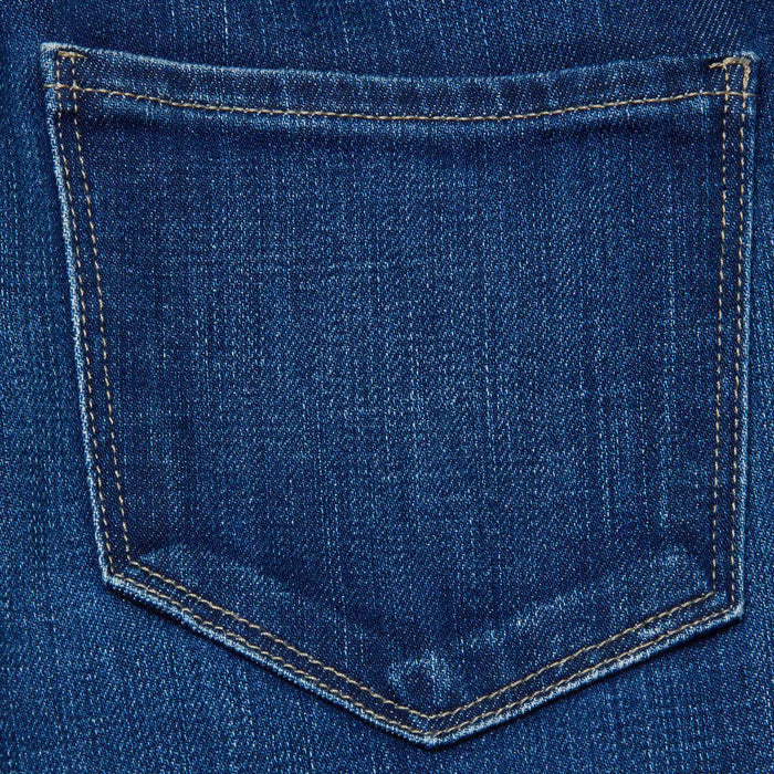 Close-up of the back pocket on the Celestia Slim-Leg Jean, featuring blue denim and visible yellow stitching around the edges.