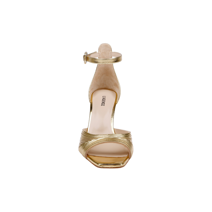 Front view of the Cici Stiletto Sandal in gold, showcasing leather pleating, an ankle strap, and a square toe against a plain white background.
