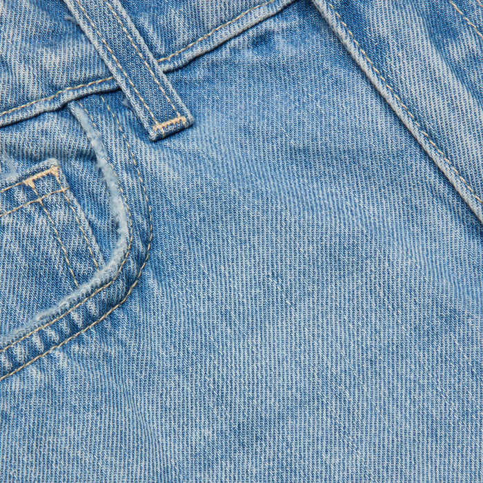 Close-up photo of the Clark Distressed Jean Short in light wash blue denim, highlighting the front pocket, belt loop, stitching, and textured fabric.