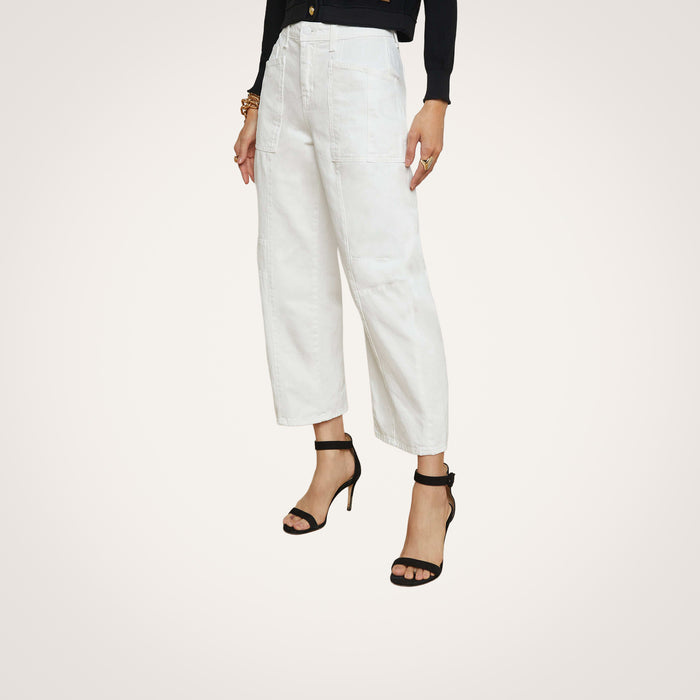 Wearing the Cody Barrel-Leg Jean in a high-rise white denim, paired with black high-heeled sandals, a person stands against a light background; the upper body is mostly out of frame.